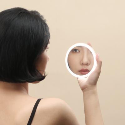 China Custom Girls Makeup Vanity Lighted Handheld Mirror Smart Portable Makeup Mirror Q Mini LED Hand Mirror for sale