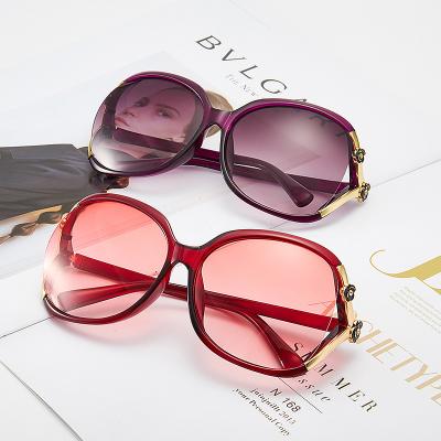 China 2022 new fashion sunglasses female camellia flower hollow point painting rose sunglasses for sale