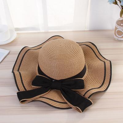 China Factory price striped bow big along the wave side of the flooopy hat lady beach straw hat for sale