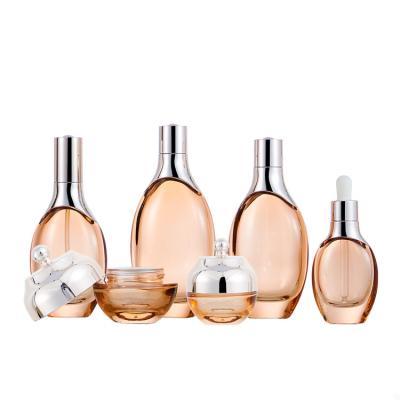 China Personal Care Cosmetics Glass Luxury Golden Bottle Set Jar Cosmetic Cream Lotion Bottle Packaging 30ML 50ML for sale