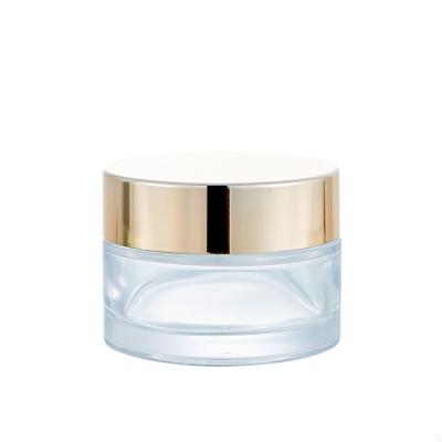 China Personal Care Top Grade Round Face Cream Cosmetic Container 100ml Clear Glass Jar With Gold Metallic Lid for sale