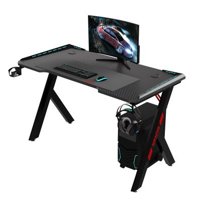 China 2021 Hot Direct Factory Selling E-sports PC Office Home Office Expandable With LED Light R-shape Gaming Desk for sale