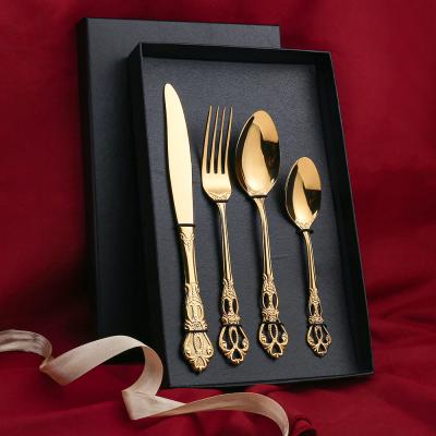 China Viable Gold Cutlery Set Boxed Flatware Western Relief Retro Hollow Steak Knife And Fork European Style Tableware for sale