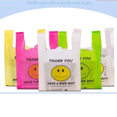 China 20x32cm Recyclable Retail Supermarket Grocery Plastic Bags Carry Out Bags Smile Gift With Handle Food Packaging for sale