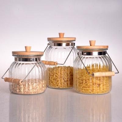 China Asian Zen Wholesale Clear Kitchen Preserve Food Spice Storage Glass Jar with Airtight Wooden Top and Handle for sale