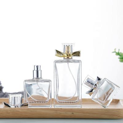 China Cosmetic Ru Star Travel Size Clear 25ml 35ml 50ml 100ml  Square Perfume Packaging Glass Pump Sprayer Bottle With Silver Gold Bow for sale