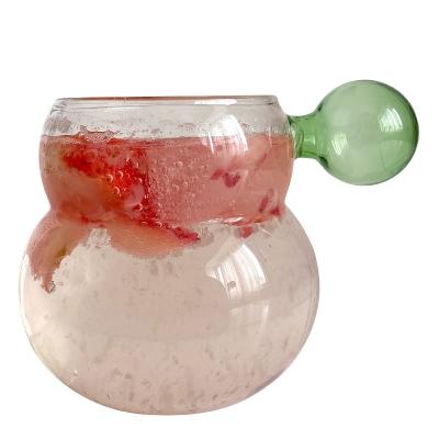 China Viable Nordic Colorful Glass Ball Handle Cup Squash Shaped High Borosilicate Single Layer Glass Cups Glass Mugs for sale