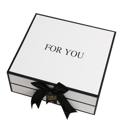 China Recycled Materials Magnet Flap Custom Luxury White Paper Apparel Box Flip Top Gift Boxes With Black Ribbon Closure for sale