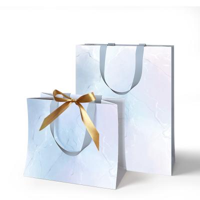 China Recycled Materials Customized Retail Shopping Sliver Jewelry Design Logo Luxury Boutique Clothing Wedding Gift Paper Bag for sale