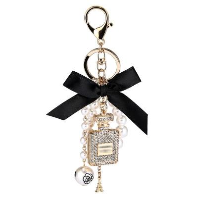 China New 2023 Creative Handmade Metal Diamond Pendant Set To Perfume Key Chain Fashion Bow Pearl Alloy Hanging Key Chain for sale