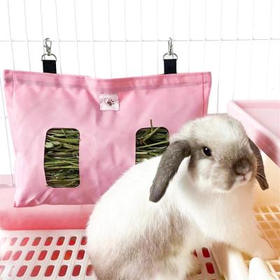 China Sustainable New Design Slow Feeder Bags Small Animal Grass Feeder Storage Nylon Waterproof Hanging Rabbit Hay Bag for sale