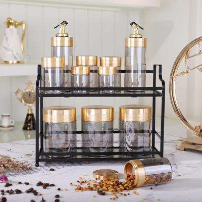 China Viable luxury kitchen decorate candy food storage canister glass jars and containers wholesale glass jar with metal rack for sale