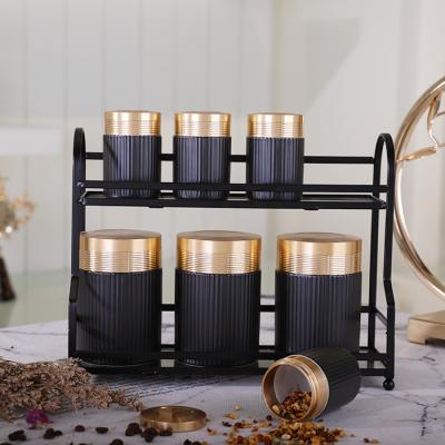 China Wholesale Viable Elegant Kitchen Black Lid Gold Tea Coffee Coffee Tea Ceramic Canister Sets Storage With Metal Rack for sale