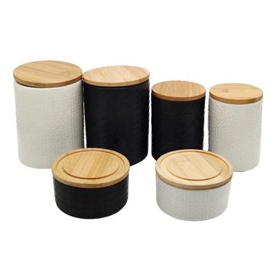 China Customized Freshness Preservation Embossed Ceramic Food Coffee Tea Sugar Kitchen Storage Jars In Various Sizes With Bamboo Or Wooden Lids for sale