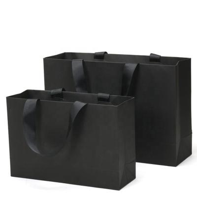 China Low MOQ Matte Black Card Paper Gift Recyclable Custom Paper Bag Kraft Paper Bag Apparel Shopping Bag With Ribbon Handle for sale