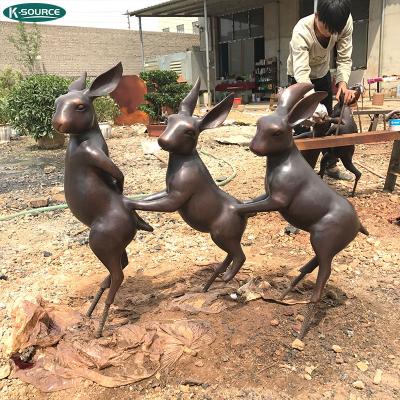 China Europe Indoor And Outdoor Living Dimensions Bronze Three Rabbits Holding Statue for sale