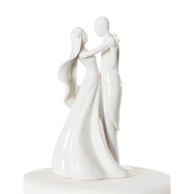 China Dancing couple figurine makes a beautiful cake topper high quality heart arch and ceramic dancing couple cake topper for sale