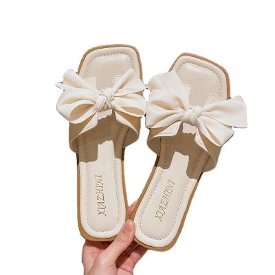 China Cushioning New Ladies Flat Slippers Indoor Non-slip Oversized Bow Decoration Leather Outdoor Slippers Ladies Open Toe Beach slippers for sale