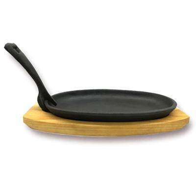 China Sustainable Cast Iron Sizzler Hot Wooden Serving Dish Pan& Rack for sale