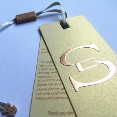 China Gold Logo Sustainable Hot Stamping Luxury Clothing Paper Hanger Label for sale