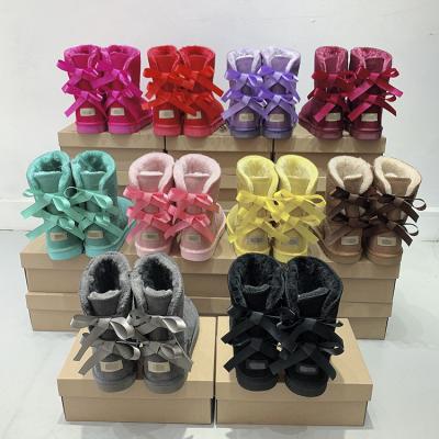 China Round Wholesale Winter Warm Fashion Ladies Sheepskin Kids Women Winter Snow Ribbon Fur Boots With Bows for sale