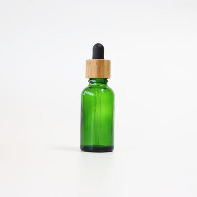 China Pharmaceutical Hot Sale 30ml CBD Essential Oil Bottles Glass Dropper Tincture Bottle Green Blue With Bamboo Cap for sale