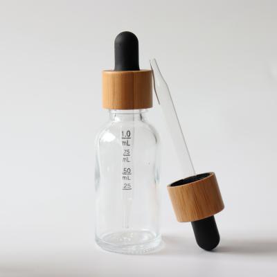 China 30ml essential oil pharmaceutical wholesale transparent tincture glass dropper bottle with bamboo lid for sale