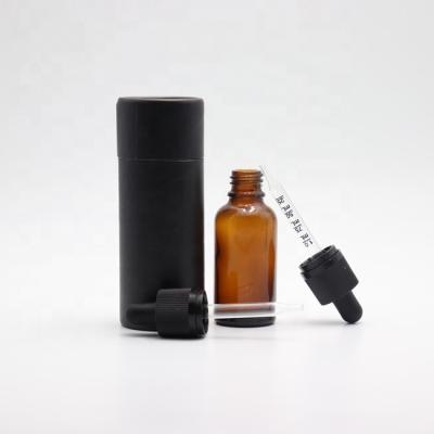 China Personal care 5ml 10ml 15ml 20ml 30ml 50ml 100ml color glass amber bottle for essential oil with black packaging tube for sale