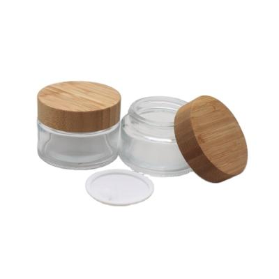 China 5ml 15ml 30ml 50ml 100ml cosmetic clear frosted glass jar with bamboo wooden lid for body cream use for sale