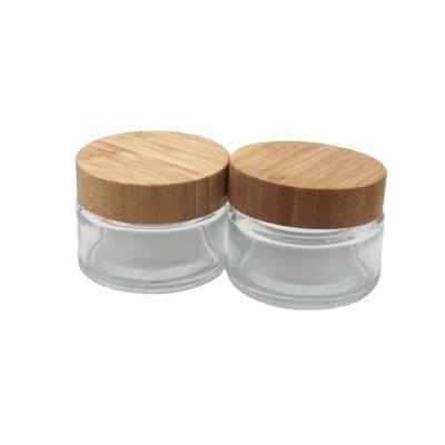 China Cosmetic empty cream jar frosted glass cosmetic jar with bamboo lid for sale