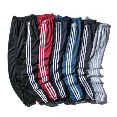 China Anti-wrinkle Mens Three-stripe Casual Pants Plus Size Track Pants Teens Slim Fit Sports Pants for sale