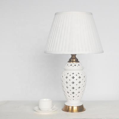 China Modern Hotel Bedroom Beside Lamp White Hollow Fishtail Pot Ceramic Table Lamp With Fabric Shade for sale