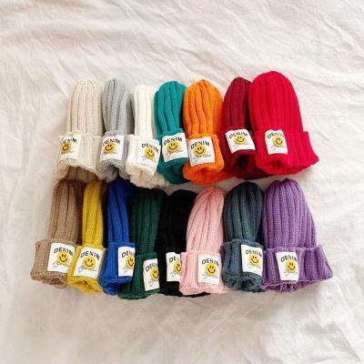 China Qy autumn and winter candy color casual children's woolen cute smile face knitted baby fashion striped warm hat for sale