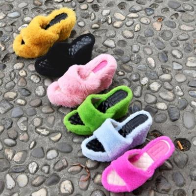 China Height increasing size 35-43 new autumn style round head wedge heel plush high rise slippers for home women's large size high-heeled slippers for sale