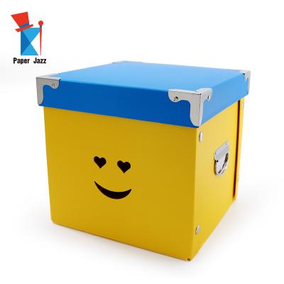 China Sustainable Smile Face Cardboard With 2 Handles Hollow-out Decoration Home Square Foldable Storage Box For Toy For Clothes for sale