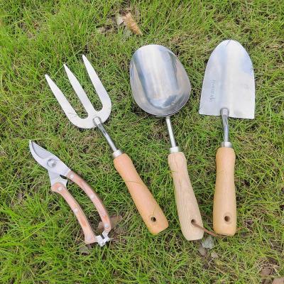 China Strong Stainless Steel Shovel Garden Fork Soil Gardening Trowel Set Shears With Wooden Handle for sale