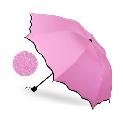 China Modern Fashion Patio Umbrella Sunshade Black Coating Magic Flower Pop Up Cheap 3 Fold Umbrella For Rain for sale