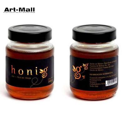 China Round Shape Viable Wholesale Jam Honey Clear Glass Jar With Black Lid for sale