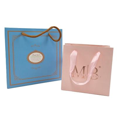 Cina Carta Kraft bianca Acquisti Abbigliamento Cosmetici Perfume Borsa regalo Luxury Handle Logo personalizzato Borsa di carta stampata per abbigliamento in vendita