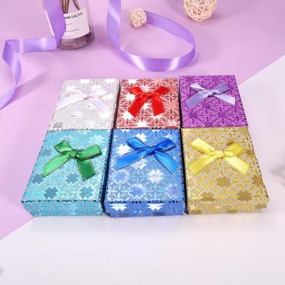 China Paper factory direct sales 7*9*3 can be customized dotsethnic sequin wind and land cover bow cardboard gift box for sale