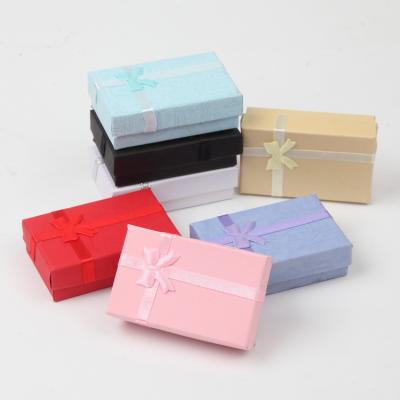 China Customized Logo Paper Stamping Gold Bow 8*5 Necklace Earrings Brooch Packaging Ring Gift Jewelry Box for sale