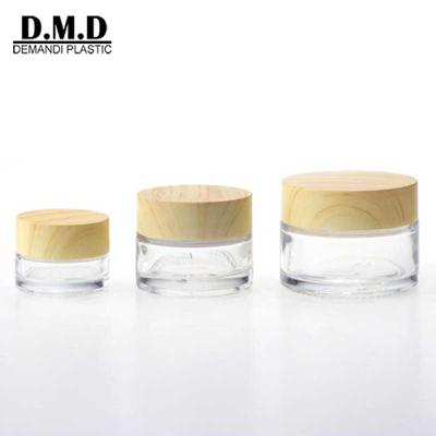 China Personal Care Luxury 5g 10grams 15ml Transparent Glass 30g 1OZ 20ml Clear Cream Storage Jar 50 Grams Glass Container With Wooden Screw Top for sale