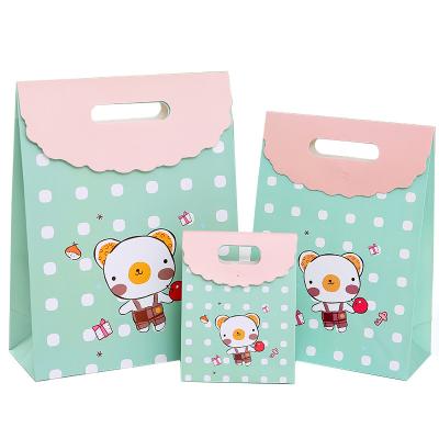 China Recyclable Custom Logo Cartoon Design Gift Paper Bag With Flap Stand Up Handle Die Cut Paper Gift Bags for sale