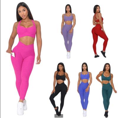 China Anti-Pilling Women Yoga Sets Breathable Cross Metal Hollow Out Bra Yoga Suit Set Womens Fitness Leggings Woman Yoga Leggings for sale