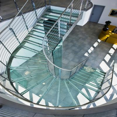 China Modern Contemporary Curved Staircase Semi Tempered Glass Steps Stainless Steel Frame Circle Stairs for sale