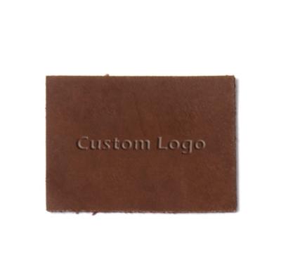 China Best Viable Price Custom Logo Own Design Leather Tag Embossed Leather Labels For Clothing Hat Bag for sale