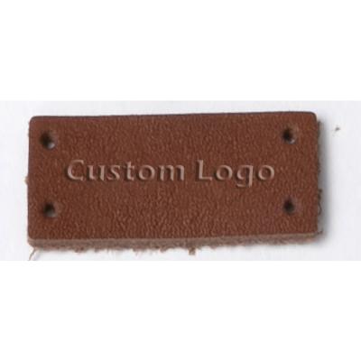 China Sustainable high quality faux debossed / embossed manufacturer / genuine leather label with custom brand logo for sale