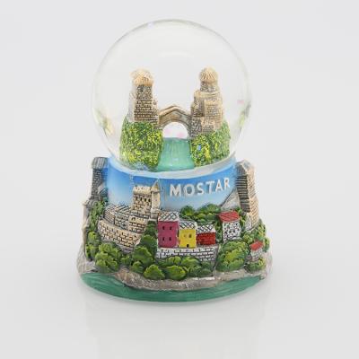 China Hand Made 45mm Water Ball Diameter Souvenir Snow Globe With Resin Base for sale