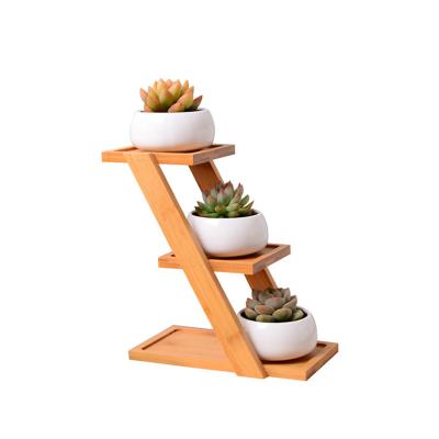 China Modern creative 3 tier bamboo shelf with round shape white ceramic flower plant pots for sale