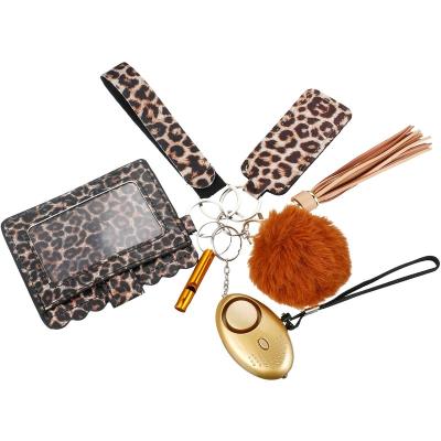 China Eco-Friendly Security Keychains Set For Women Girls Leopard Defense Bracelet Lip Balm Stick Lip Balm Tracker Alarm Key Chain Lanyard for sale